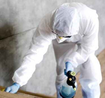 full-shot-man-with-suit-disinfecting-stairs