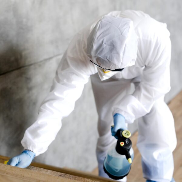 full-shot-man-with-suit-disinfecting-stairs