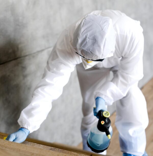 full-shot-man-with-suit-disinfecting-stairs