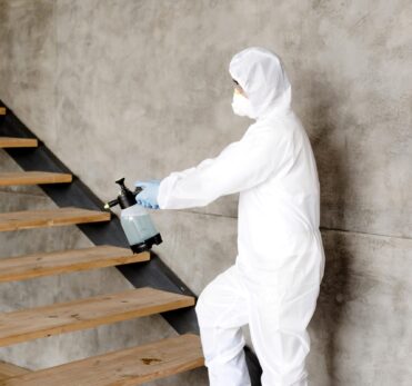 side-view-man-disinfecting-stairs